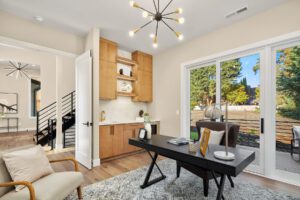 Bright modern home office with stylish decor, large glass doors, and inviting natural light.