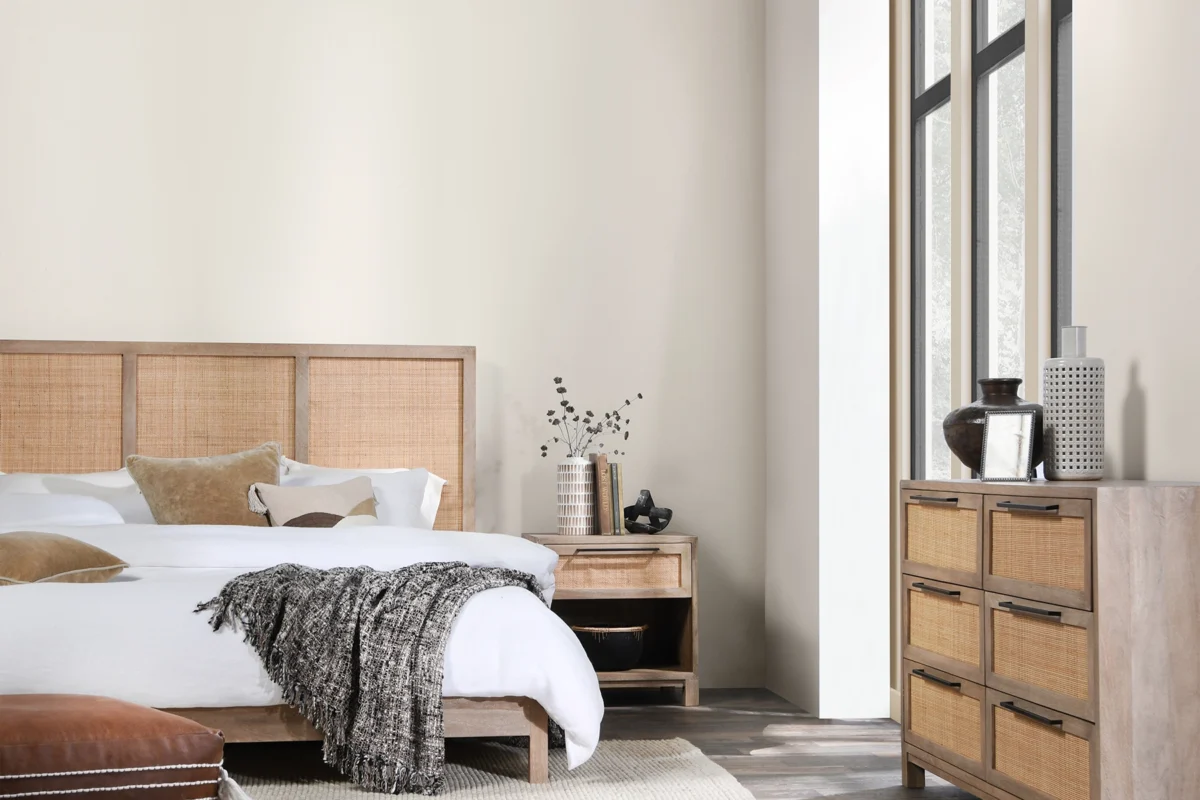 Cozy minimalist bedroom featuring wood and rattan accents for a serene retreat. For design inspiration.