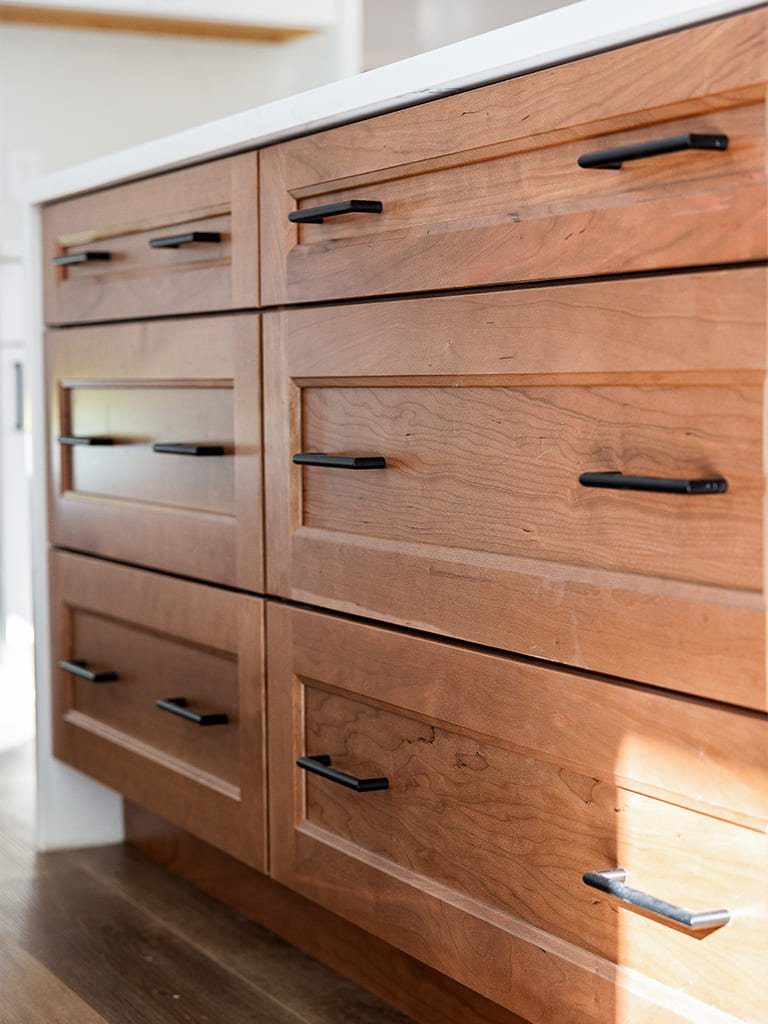 Sleek wooden kitchen drawers with black hardware — Kirkland Home, Ariana Designs