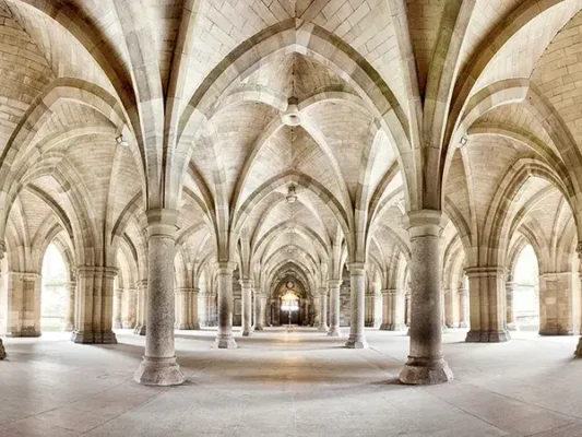 Gothic architecture design highlights Glasgow Universitys cloisters with intricate arches and elegant columns.