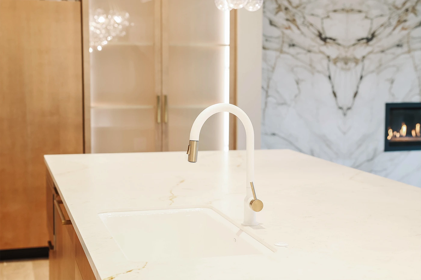 Sleek minimalist kitchen with elegant gold accents and white countertop — Medina, Ariana Designs
