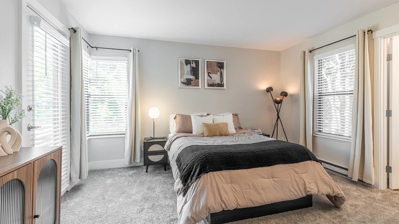 A beautifully staged bedroom designed by nearby interior design companies, featuring elegant furnishings and a relaxing ambiance.