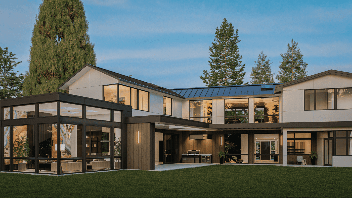 Contemporary residential exterior showcasing a modern home with large windows, a sleek design, and an inviting outdoor space surrounded by greenery.