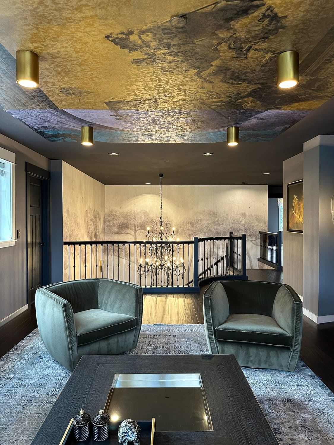 Contemporary living space adjacent to staircase — Ariana Designs