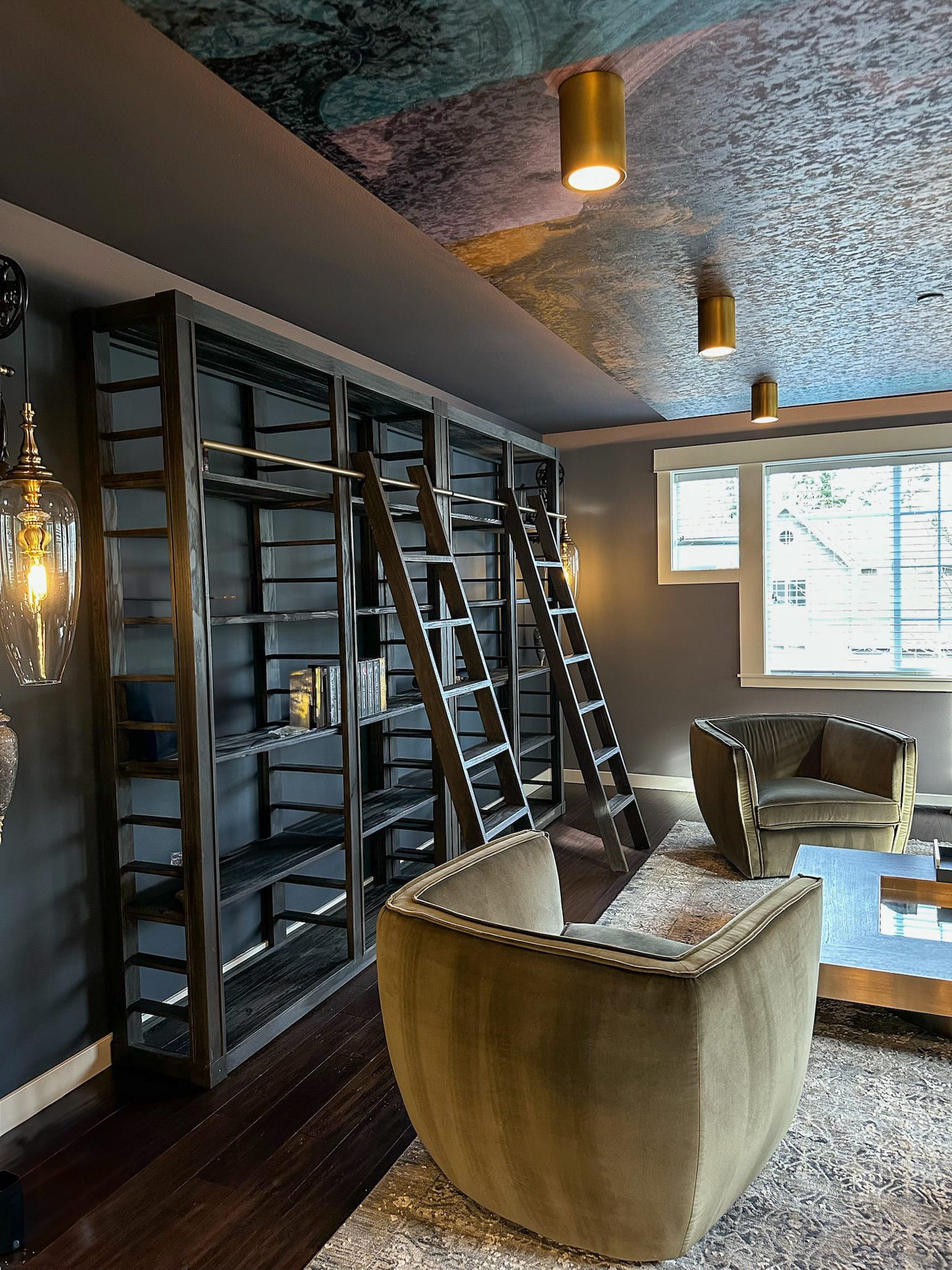 Cozy reading nook with dark wood shelves and ceiling mural — Kirkland artful library