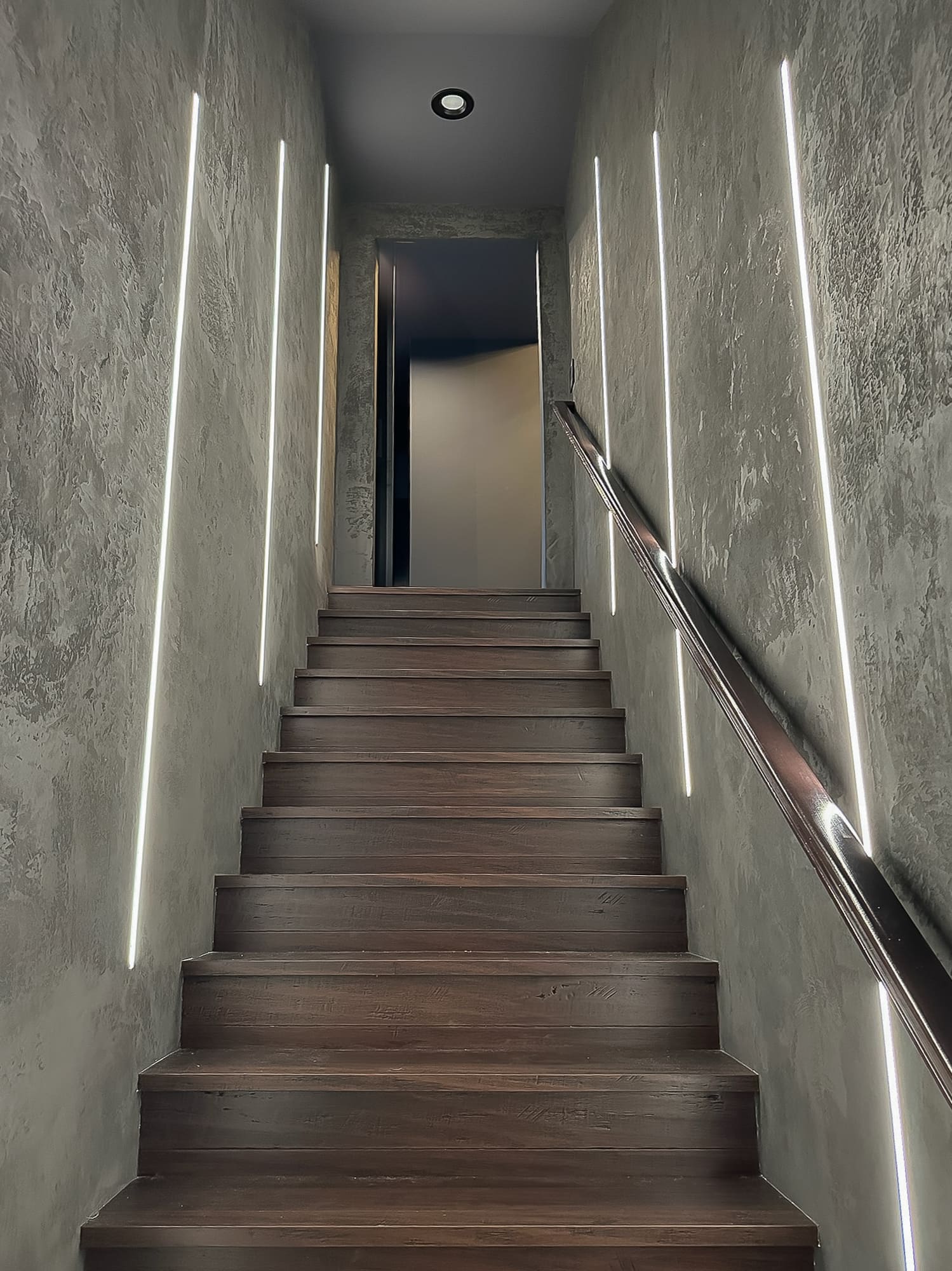 Modern staircase with dark wall treatment — Ariana Designs