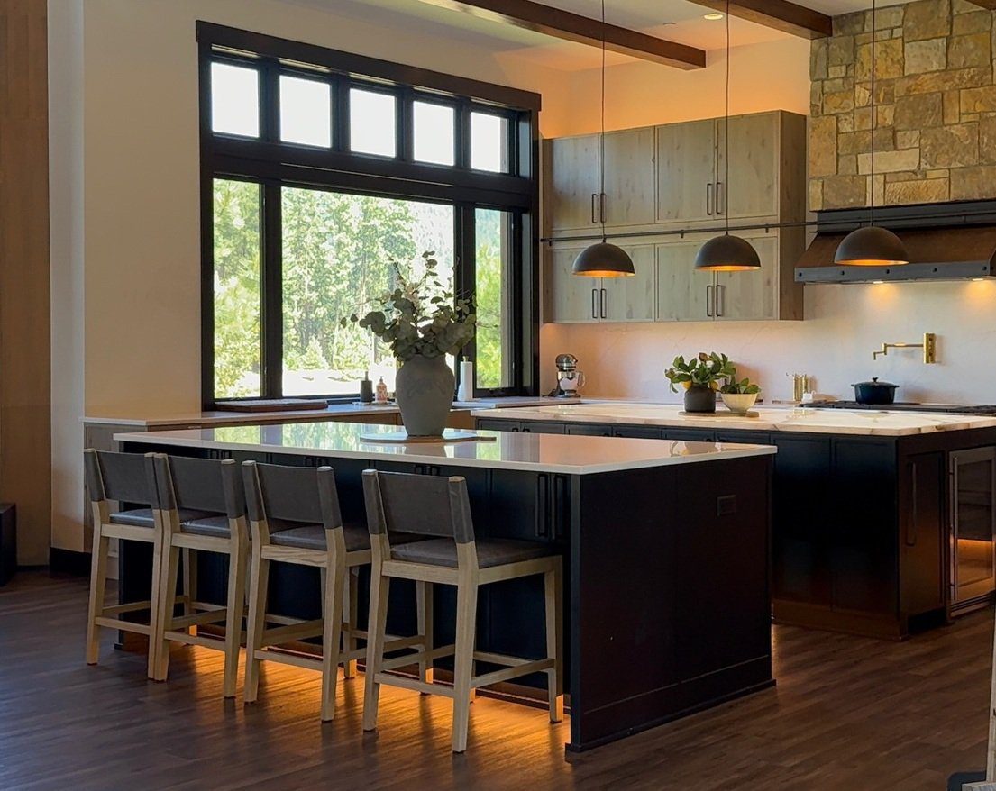Black kitchen island with LED cabinet lights — Ariana Designs & Interiors