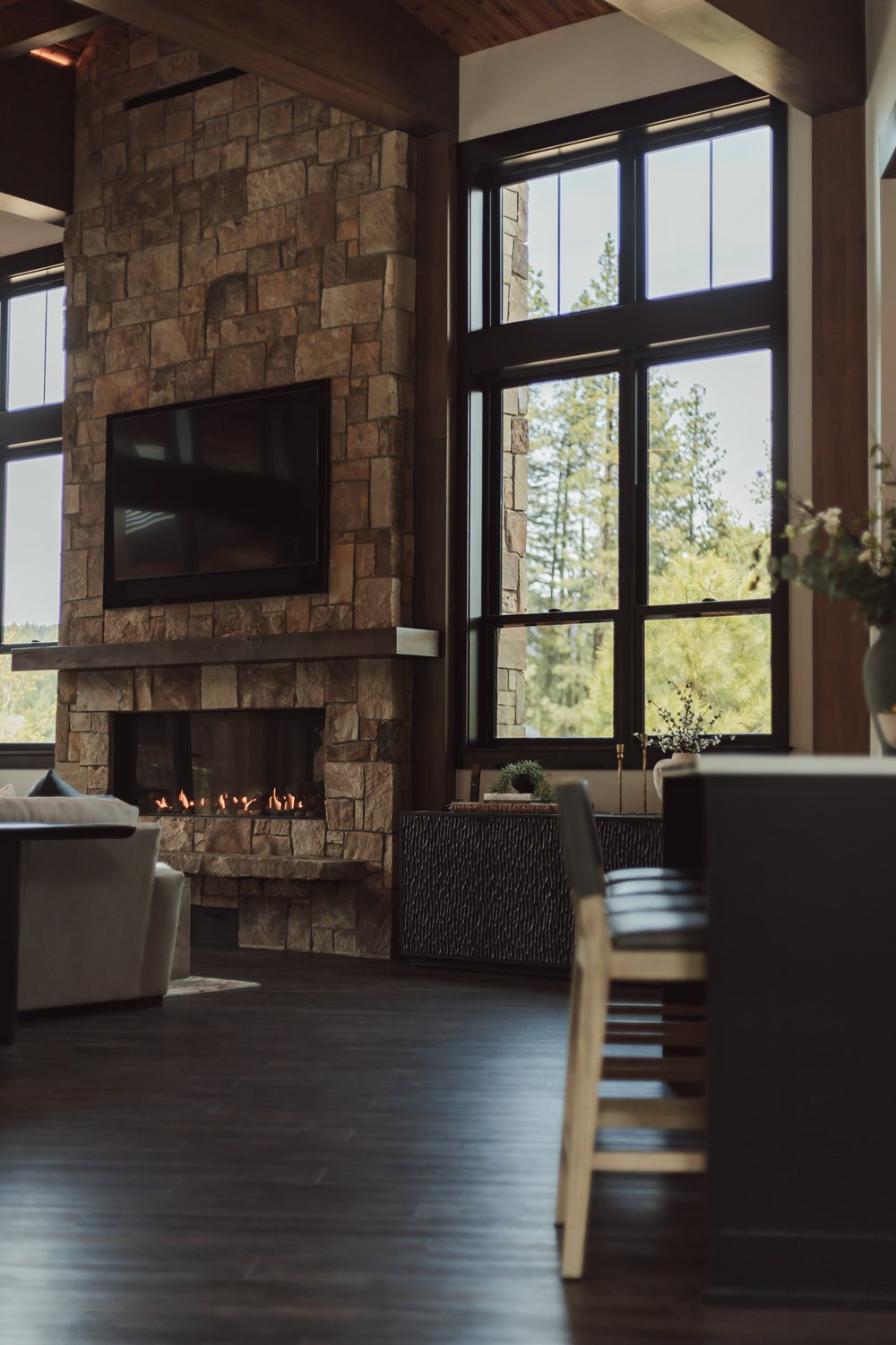 Side view of the stone fireplace and lounge — Suncadia family room, Ariana Designs & Interiors