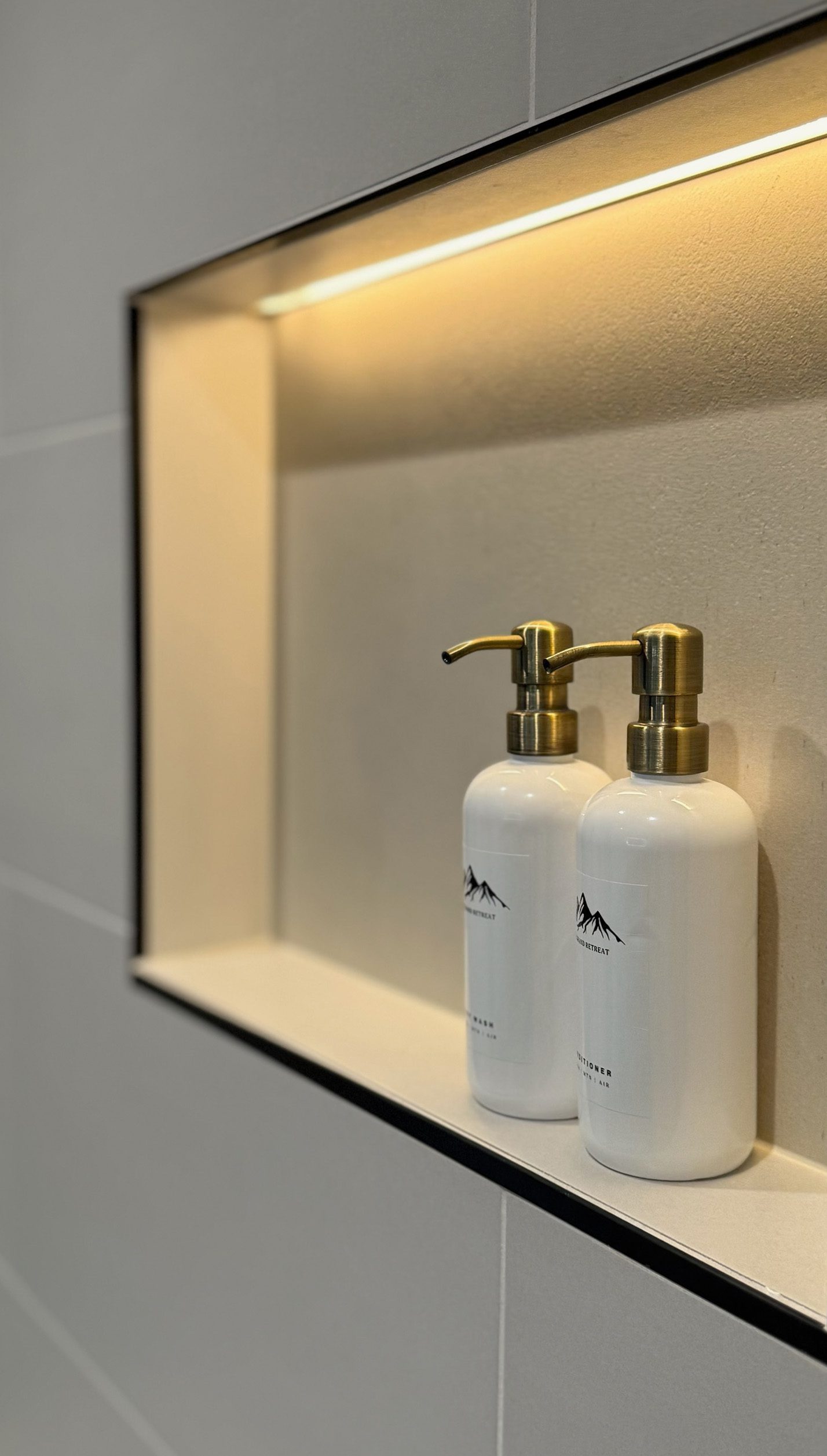 Gold accents and natural tile — Ariana Designs & Interiors, Suncadia bathroom