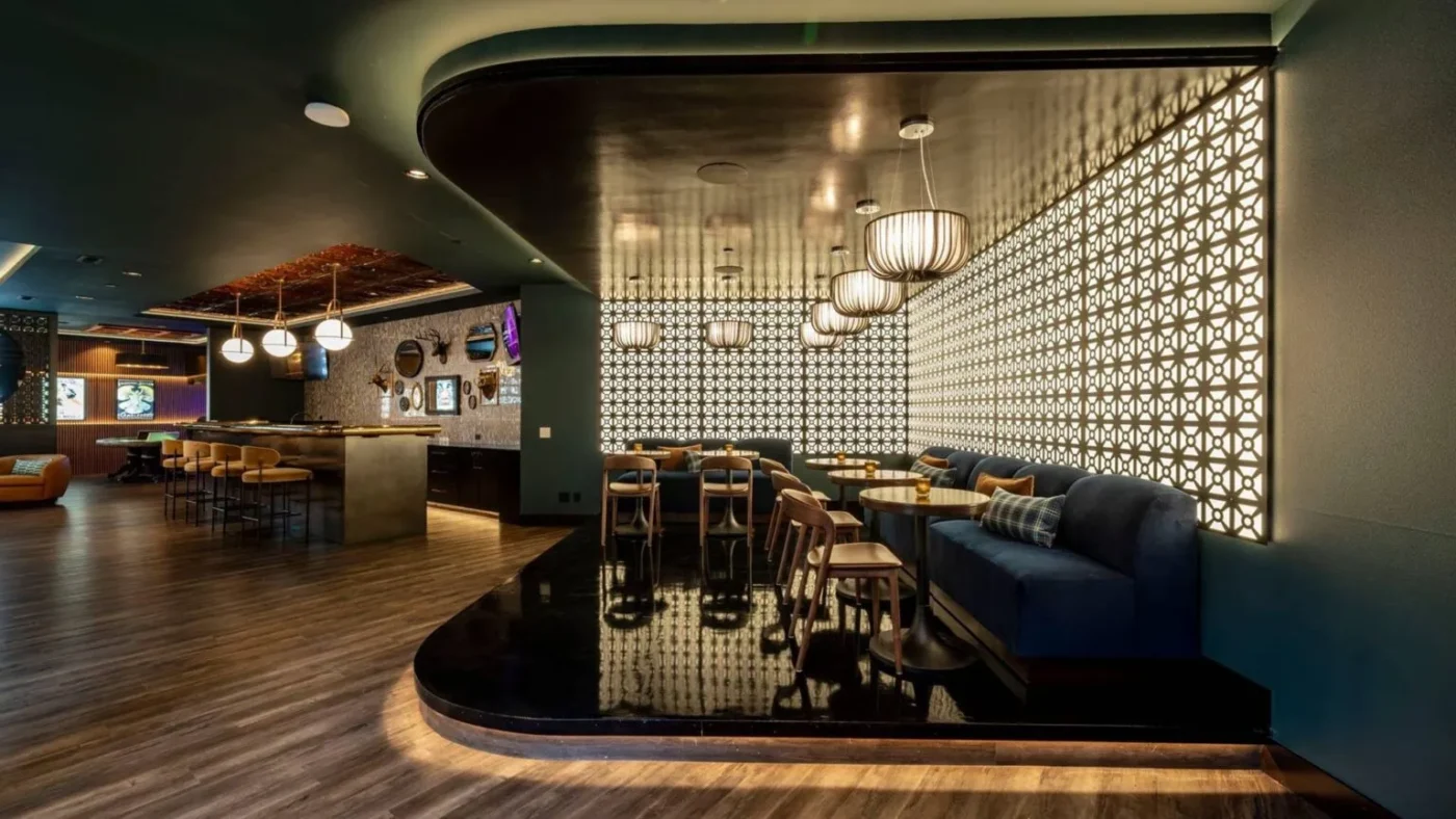 Contemporary lounge with statement lighting and pattern walls, designed by interior designer Yarrow Point WA at Ariana Designs & Interiors