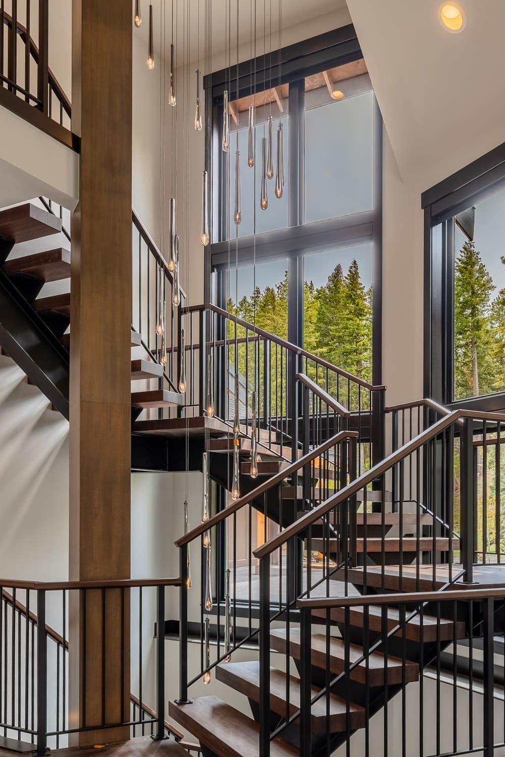 Floating staircase with open risers and blackened steel stringer — Suncadia, Ariana Designs