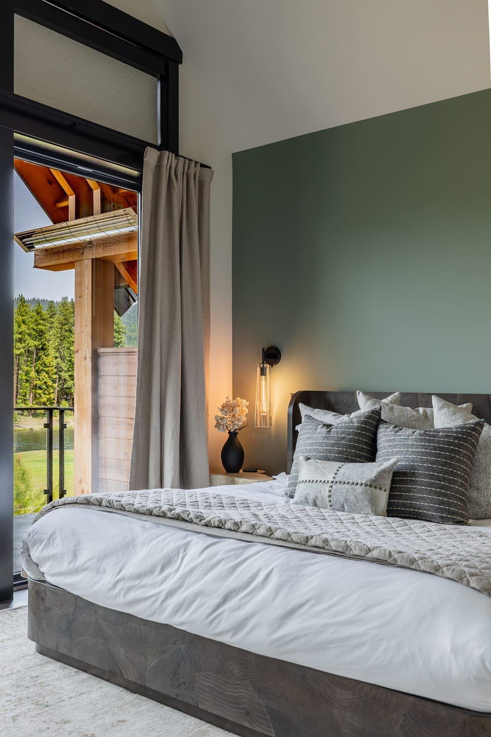 Primary suite with sage accent wall and tufted platform bed — Suncadia, Ariana Designs