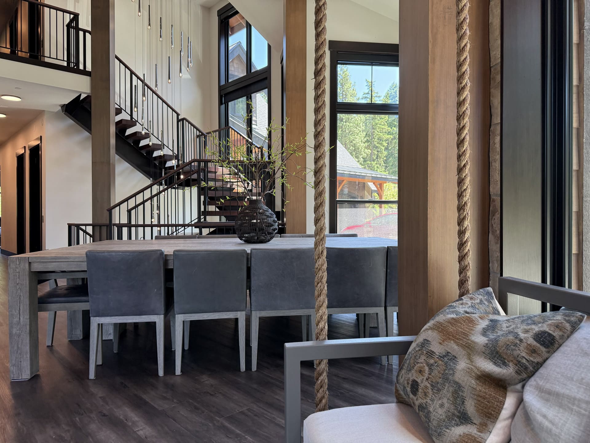 Dining area with leather chairs and natural wood column in Suncadia home