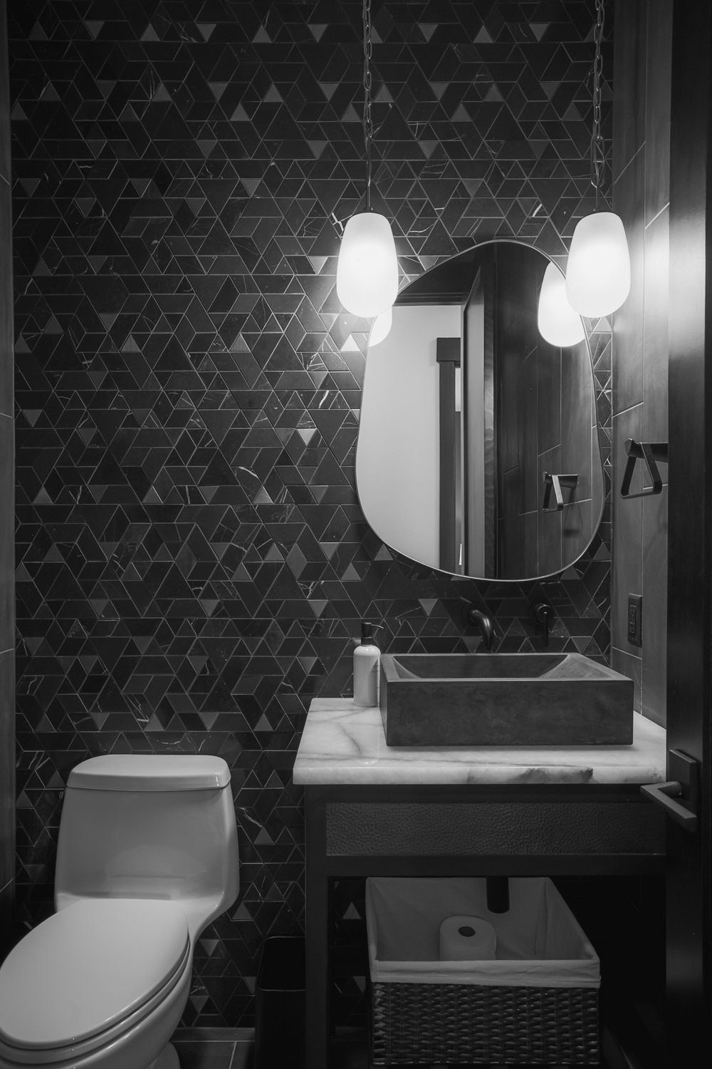 Brass pendant lighting over asymmetric mirror — Ariana Designs, Suncadia Powder Room